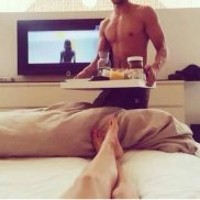 male serving her breakfast in bed